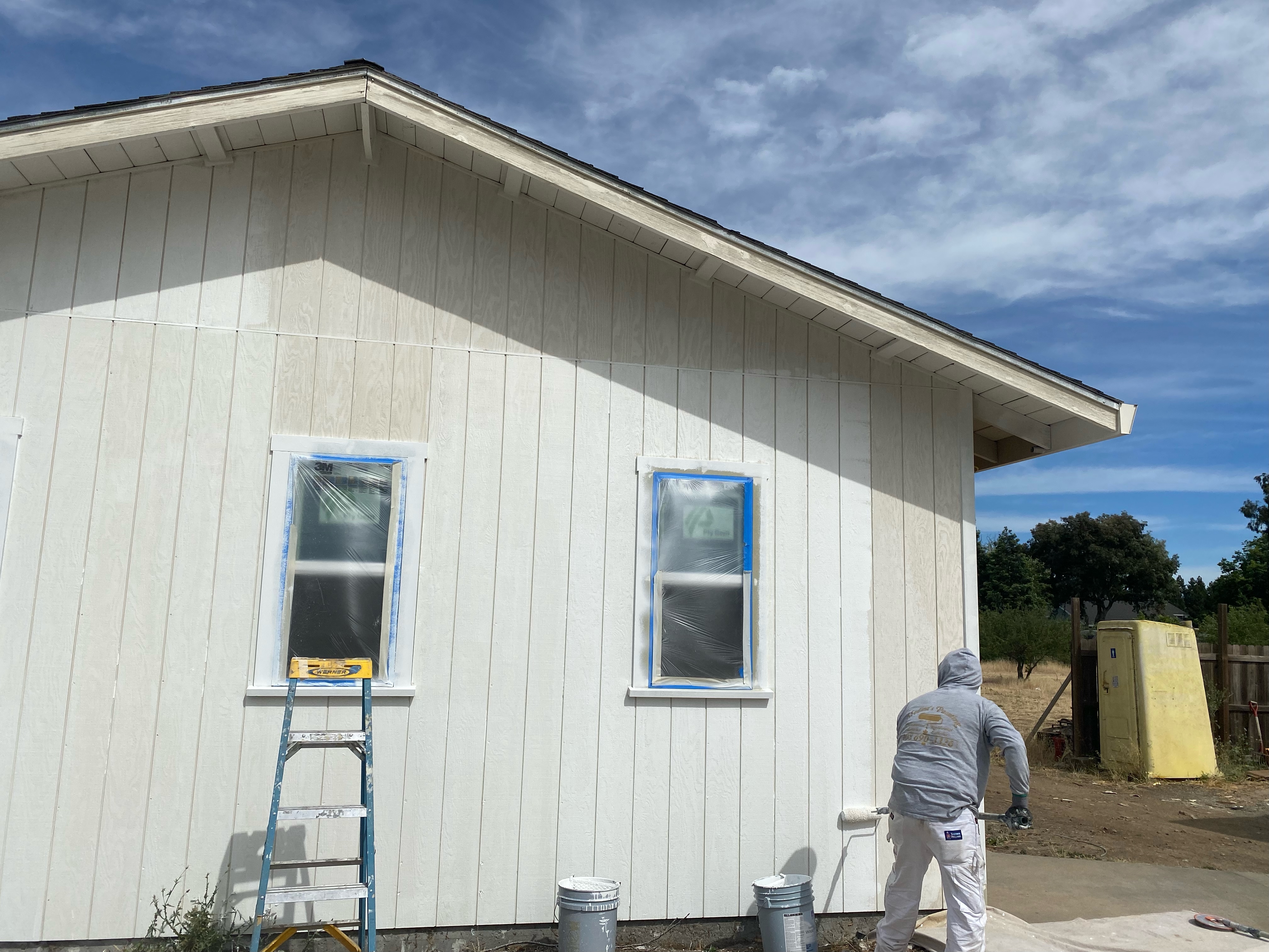 man painting residential building